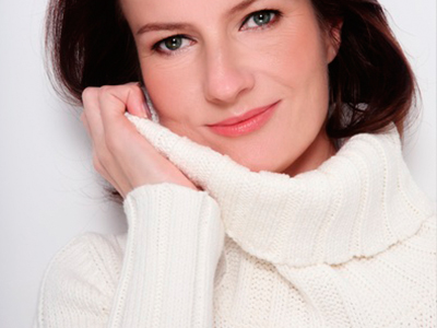 closeup of woman smiling after receiving facial fillers.