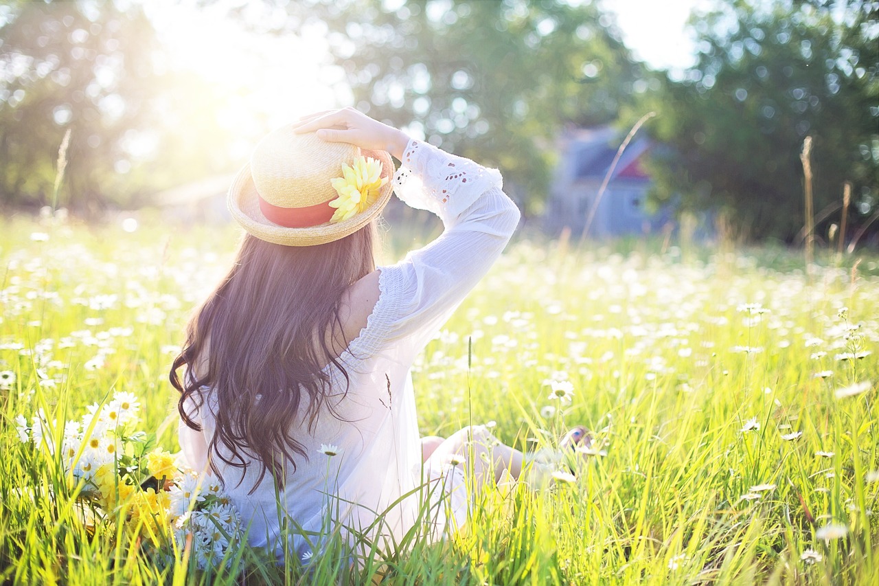 spring skincare tips 2023 - woman in field of grass